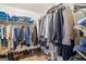 Spacious walk-in closet with organized storage, hanging rods, shelves, and shoe racks at 1214 Lambeth Se Way, Conyers, GA 30013
