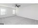 Spacious bedroom with a modern ceiling fan, two windows, and cozy neutral carpeting at 3333 Arabian Farm Ln, Dacula, GA 30019