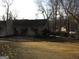 Home's backyard features a large open space with scattered trees, offering plenty of room for outdoor enjoyment at 5848 Navarre Ct, Stone Mountain, GA 30087
