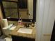 Bathroom with granite countertop, framed mirror, and essential toiletries for everyday use at 5848 Navarre Ct, Stone Mountain, GA 30087