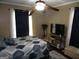 Comfortable bedroom with a gray patterned bedding set, dark curtains, and modern furniture at 5848 Navarre Ct, Stone Mountain, GA 30087