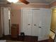 Bedroom with a large closet with double doors, offering ample storage space and organization at 5848 Navarre Ct, Stone Mountain, GA 30087