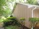 Exterior view with lush shrubs bordering the home, showcasing the clean lines and well-maintained landscaping at 5848 Navarre Ct, Stone Mountain, GA 30087