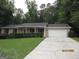 Single-story home featuring a well-maintained yard and attached one car garage at 5848 Navarre Ct, Stone Mountain, GA 30087