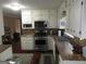 The kitchen features modern appliances, white cabinets, beautiful countertops, and mosaic backsplash at 5848 Navarre Ct, Stone Mountain, GA 30087