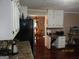 The kitchen features white cabinets and countertops with view into the dining area at 5848 Navarre Ct, Stone Mountain, GA 30087