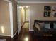 Living room with a brown sofa and an open doorway leading to a hallway with additional rooms at 5848 Navarre Ct, Stone Mountain, GA 30087