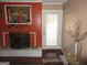 Living room featuring a unique orange wall with a fireplace and a door leading to the outside at 5848 Navarre Ct, Stone Mountain, GA 30087