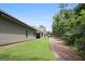 View of the side of a home with lawn and a path through the trees at 3112 Patriot Sq, Marietta, GA 30064