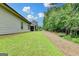 Wide view of backyard featuring green grass, trees and view of screened in porch at 3112 Patriot Sq, Marietta, GA 30064