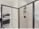 Bathroom with glass enclosed tiled shower and view into the bedroom at 3112 Patriot Sq, Marietta, GA 30064