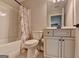Well lit bathroom featuring a tub, toilet, and vanity with a framed mirror and storage at 3112 Patriot Sq, Marietta, GA 30064