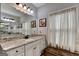 Bathroom features a vanity with granite countertop, a mirror, and decorative accents at 3112 Patriot Sq, Marietta, GA 30064
