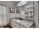 Bathroom features a vanity with granite countertop, a mirror, and decorative accents at 3112 Patriot Sq, Marietta, GA 30064