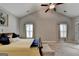 A bedroom with two windows, ceiling fan, and a bed with yellow blanket and a blue throw at 3112 Patriot Sq, Marietta, GA 30064