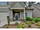 Inviting front porch with seating and decorative touches, enhanced by lush, colorful landscaping at 3112 Patriot Sq, Marietta, GA 30064