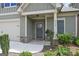 Inviting front porch with stone accents, a gray front door, and manicured landscaping at 3112 Patriot Sq, Marietta, GA 30064
