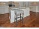 Kitchen island with seating, granite countertops, and hardwood floors at 3112 Patriot Sq, Marietta, GA 30064
