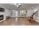 Open living room featuring hardwood floors, a fireplace, and natural light from a window with curtains at 3112 Patriot Sq, Marietta, GA 30064