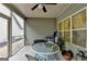 Comfortable screened porch with a ceiling fan, glass topped table, and relaxing seating at 3112 Patriot Sq, Marietta, GA 30064