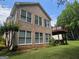 Exterior shot showcasing the back of the house, highlighting the multiple windows and partial deck at 133 Sea Island Dr, Peachtree City, GA 30269