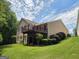 View of the back of the home with a large deck overlooking the backyard, surrounded by lush greenery at 133 Sea Island Dr, Peachtree City, GA 30269