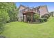Expansive backyard featuring a two-story deck and mature trees, creating a private outdoor oasis at 133 Sea Island Dr, Peachtree City, GA 30269