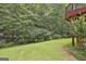 Green backyard with trees and vegetation at 133 Sea Island Dr, Peachtree City, GA 30269