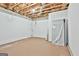 Unfinished basement space with exposed wood ceiling and concrete floor offering lots of potential at 133 Sea Island Dr, Peachtree City, GA 30269