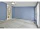 Large primary bedroom with neutral carpet and blue accent wall at 133 Sea Island Dr, Peachtree City, GA 30269