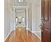 Elegant foyer featuring hardwood floors, decorative columns, and a view of the living room fireplace at 133 Sea Island Dr, Peachtree City, GA 30269
