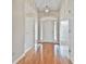 Bright foyer with hardwood floors, a white front door, and a decorative light fixture at 133 Sea Island Dr, Peachtree City, GA 30269