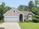 Charming single-story home with a two-car garage, brick and stucco facade, well-maintained landscaping, and a welcoming entrance at 133 Sea Island Dr, Peachtree City, GA 30269