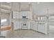 Bright kitchen with white cabinets, appliances, and tile floors at 133 Sea Island Dr, Peachtree City, GA 30269