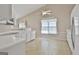 Open concept kitchen with white appliances, tile flooring, and ample natural light at 133 Sea Island Dr, Peachtree City, GA 30269