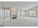 Bright living room featuring a fireplace, large windows, and neutral decor at 133 Sea Island Dr, Peachtree City, GA 30269