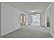 Spacious living room with neutral carpet, trim, and walls, and a view into adjacent rooms at 133 Sea Island Dr, Peachtree City, GA 30269