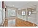 Living room featuring wood floors, built-in shelving and a large window offering natural light at 133 Sea Island Dr, Peachtree City, GA 30269