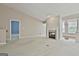 Bright living room showcasing a fireplace, carpet floors and views into other living spaces in an open concept at 133 Sea Island Dr, Peachtree City, GA 30269