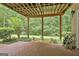 Covered patio with brick floor and view of wooded backyard at 133 Sea Island Dr, Peachtree City, GA 30269