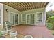 Covered patio featuring brick floor, a view of wooded backyard, and access to the interior at 133 Sea Island Dr, Peachtree City, GA 30269