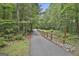 Neighborhood walking path lined by trees and a split rail fence at 133 Sea Island Dr, Peachtree City, GA 30269
