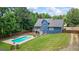 Spacious backyard features a sparkling pool, covered patio, and well-maintained lawn at 150 Surrey Chase Dr, Social Circle, GA 30025