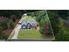 Aerial view of home featuring beautiful landscaping, mature trees, detached garage and long driveway at 150 Surrey Chase Dr, Social Circle, GA 30025
