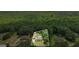 Aerial view of property showcasing its location nestled amongst mature trees in a serene setting at 150 Surrey Chase Dr, Social Circle, GA 30025