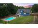 Spacious backyard features a sparkling pool, covered patio, and well-maintained lawn at 150 Surrey Chase Dr, Social Circle, GA 30025