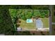 Aerial view of home showcasing a private backyard with an in-ground pool and mature trees at 150 Surrey Chase Dr, Social Circle, GA 30025