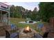 Backyard featuring in-ground pool, shed, and fire pit area surrounded by chairs in an outdoor setting at 150 Surrey Chase Dr, Social Circle, GA 30025