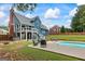 Backyard featuring a pool, hot tub, and a covered deck, perfect for outdoor entertainment and relaxation at 150 Surrey Chase Dr, Social Circle, GA 30025