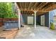 Backyard under the porch with a hot tub, access doors and outdoor storage space at 150 Surrey Chase Dr, Social Circle, GA 30025